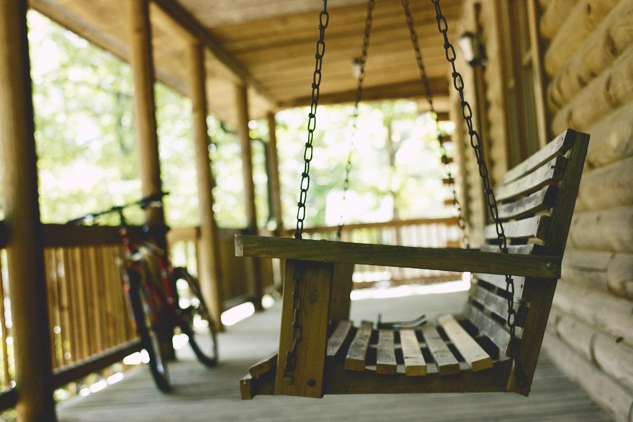 Peaceful front porch with porch swing and bicycle in Middlesex NJ – Realtor Lorraine Macaluso helping families find their perfect New Jersey home.