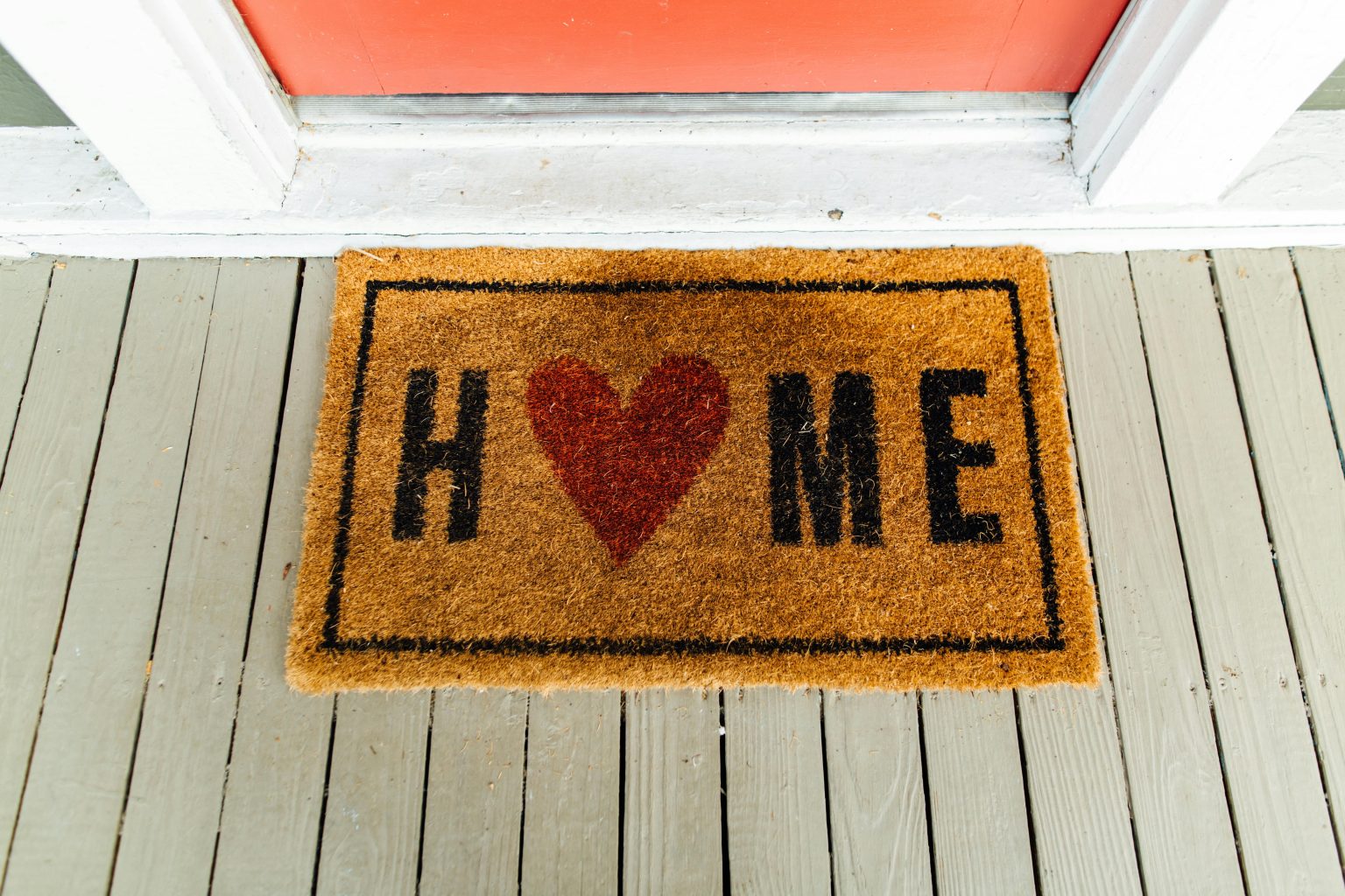 Welcome mat with heart and the word Home on front porch in New Jersey – Realtor Lorraine Macaluso helping buyers and sellers find homes they love.
