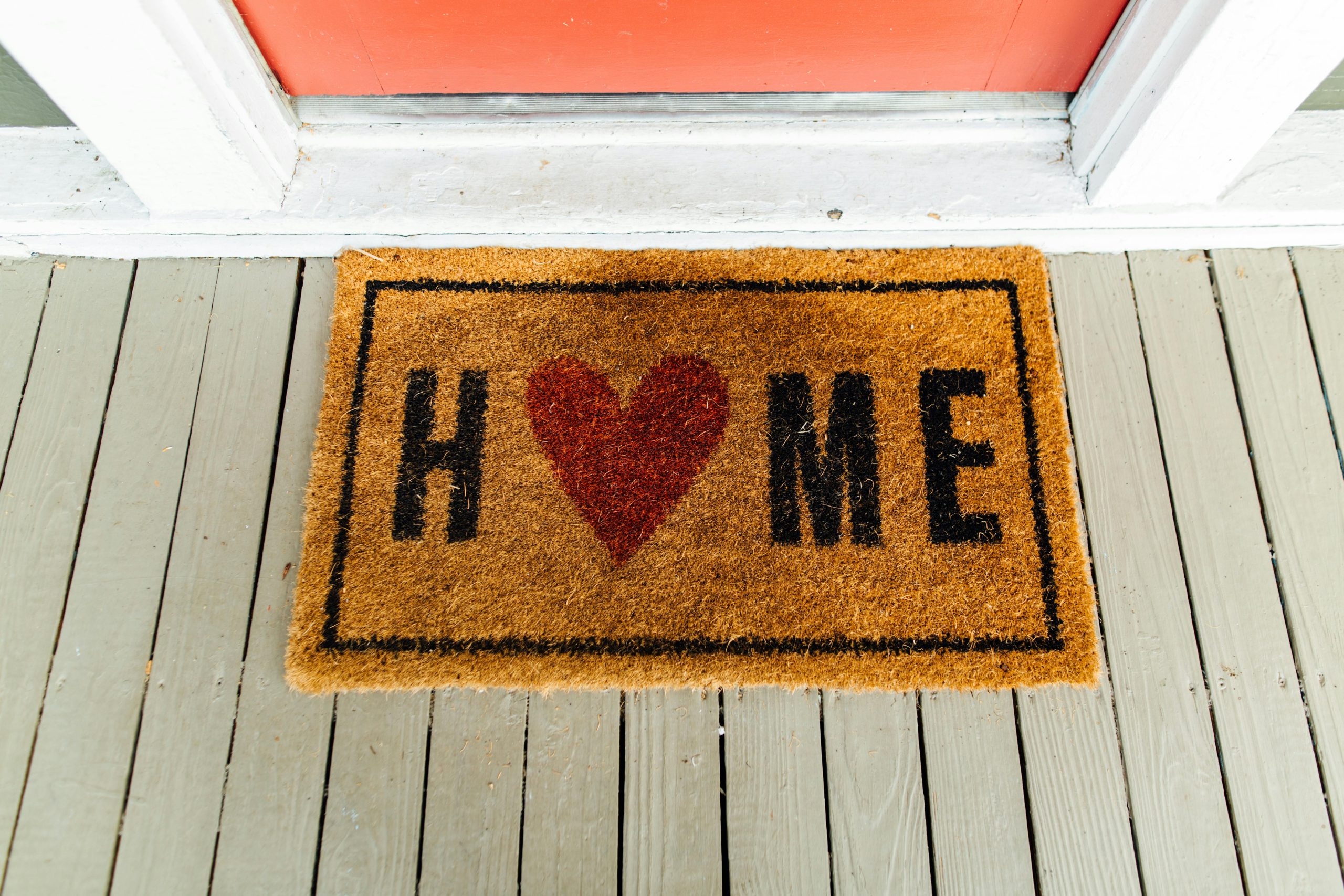 Welcome mat with heart and the word Home on front porch in New Jersey – Realtor Lorraine Macaluso helping buyers and sellers find homes they love.